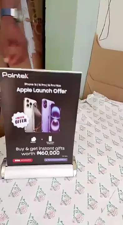 Compact Pointek iPhone launch tabletop roll-up banner stand displayed on a counter.